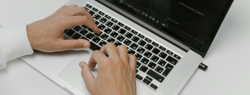 Free Hands on a Laptop Keyboard Stock Photo